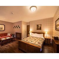 The Wooden Floors Vintage Furniture And Tartan Accents Create A Comfy Room